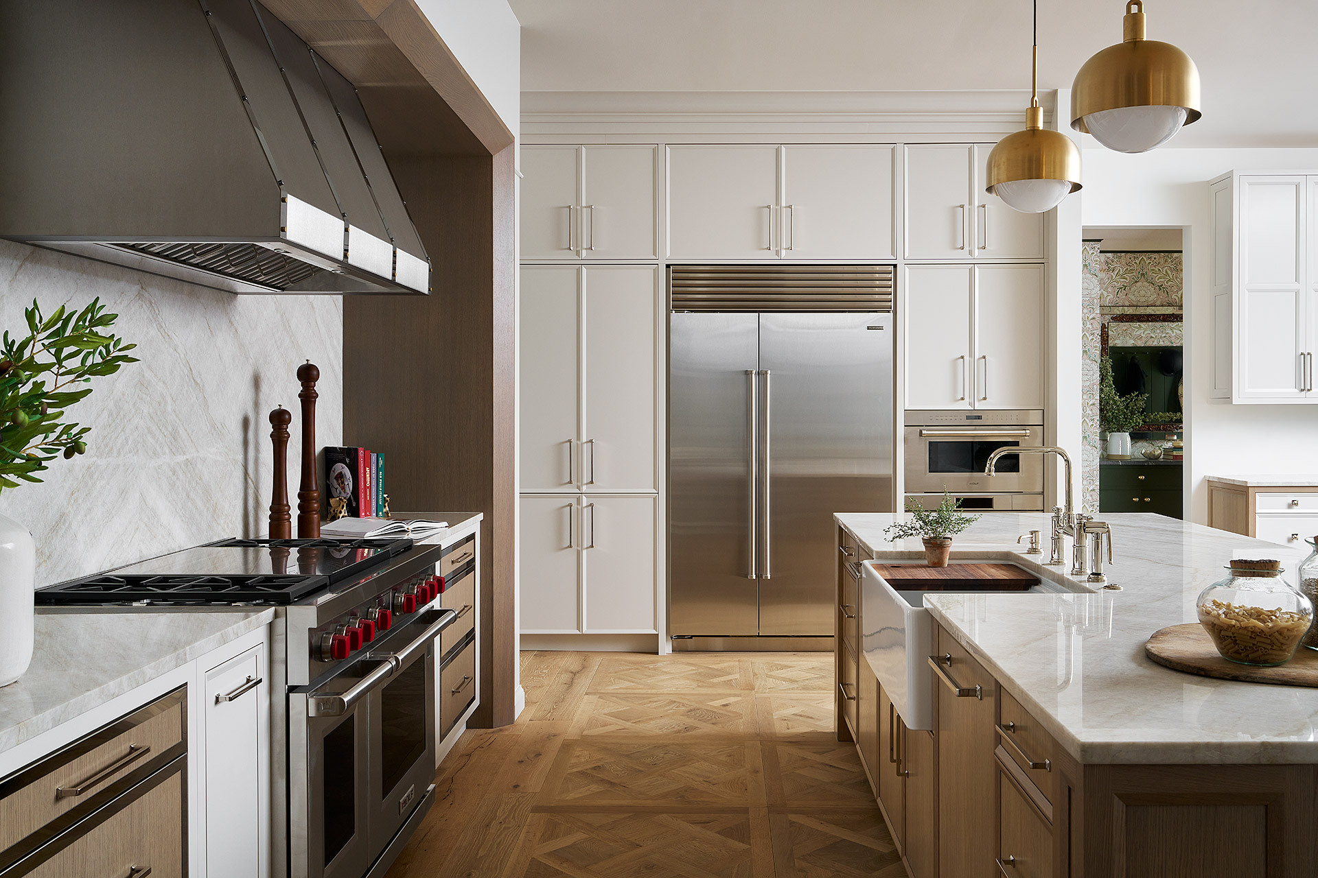 Tall white kitchen cabinets surrounding a stainless steel fridge